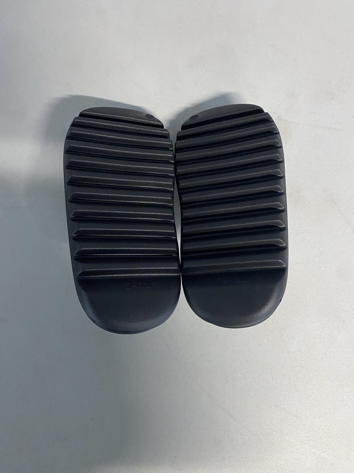 Outsole of a black slide showing the YS-01 marking